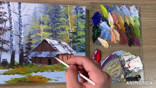 a person paints on canvas while painting landscape