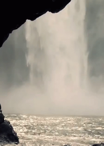 a person is walking up an ocean cliff