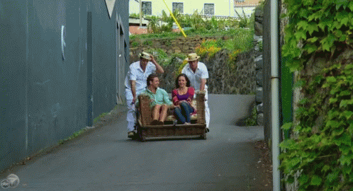 a group of people who are standing in a luggage cart