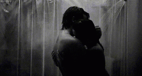 the man and woman are standing in front of the shower