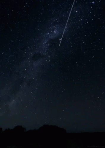 an airplane is flying in the night sky