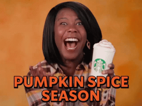a person holding a cup and a pumpkin spice syrup