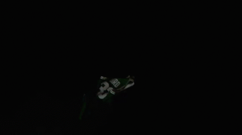 a ski jump is in the dark with snow