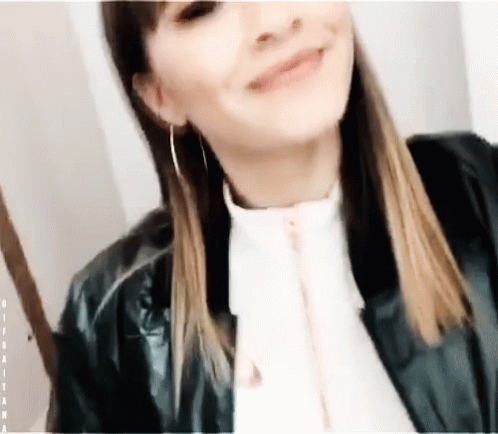 a young lady wearing a leather jacket smiles