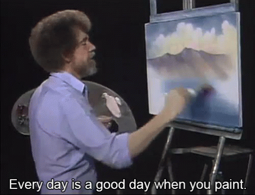 a man that is painting on an easel