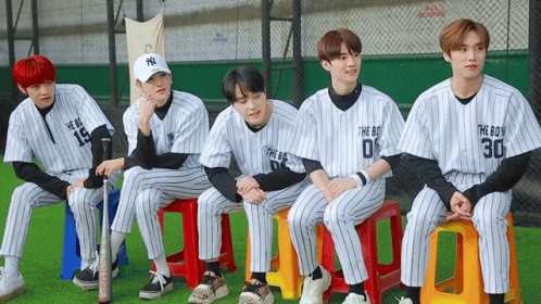 some baseball players sitting down for a team po