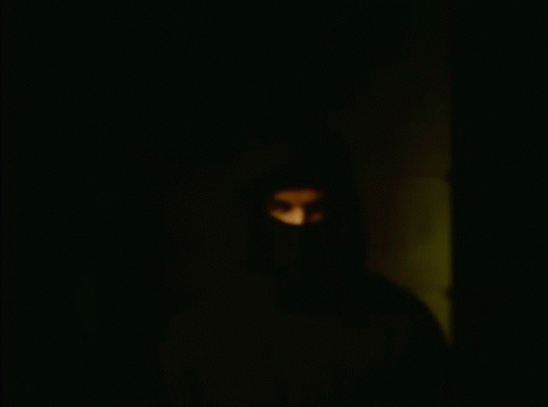 a black man in a hooded jacket with glowing eyes
