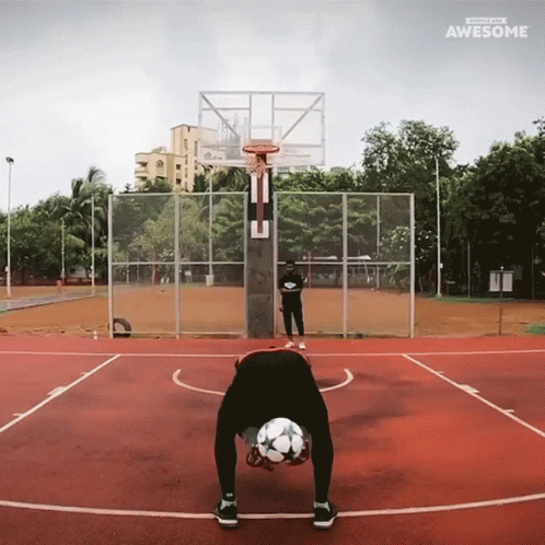 a person with a ball standing on their knees