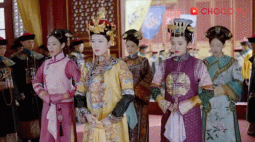 chinese style brides in costume are standing side by side