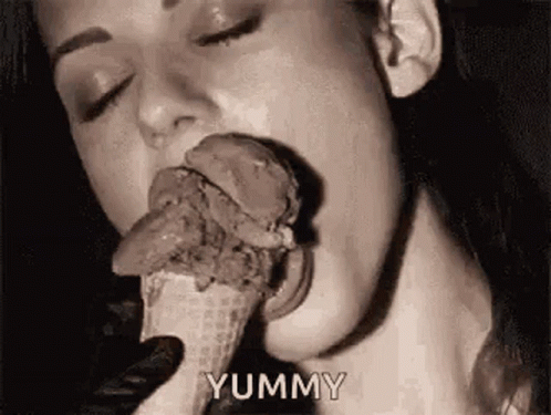 a woman eating an ice cream cone with her tongue