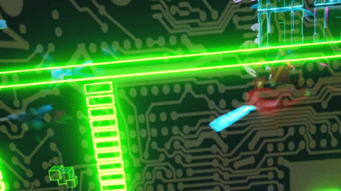 close up of the top of a circuit board with green laser lights and an over sized red dot