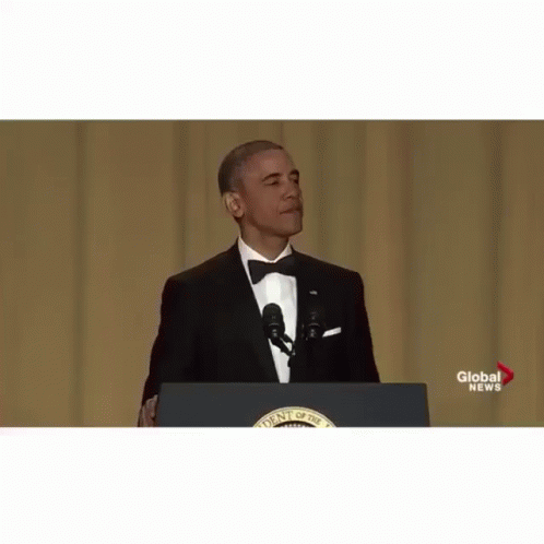 president obama speaking from the podium while wearing a suit