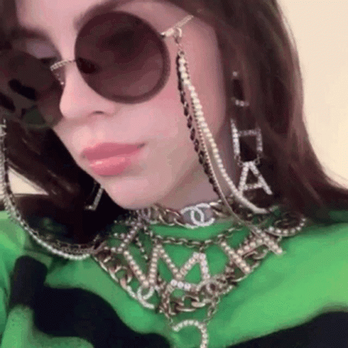 a woman wearing some metal chains and glasses