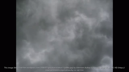 the plane is flying through a cloudy sky