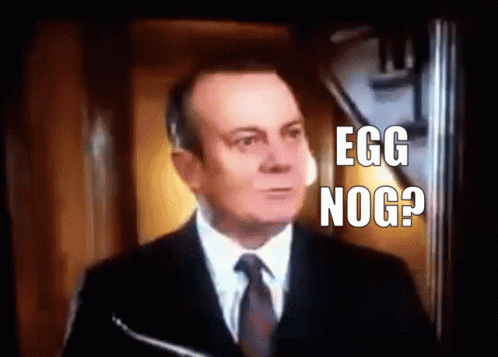 a man wearing a suit and tie with the words'egg nog?'in front of him