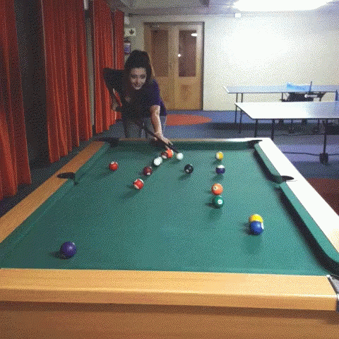 a child playing a game on a pool table