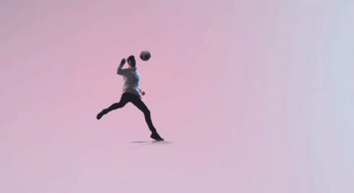 a person jumping up and holding a ball in the air