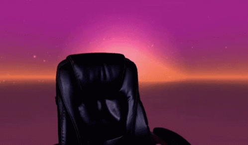 a black office chair sitting in front of a purple and blue backdrop