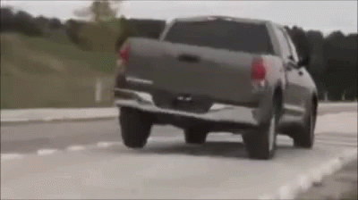 a suv that is driving down the road