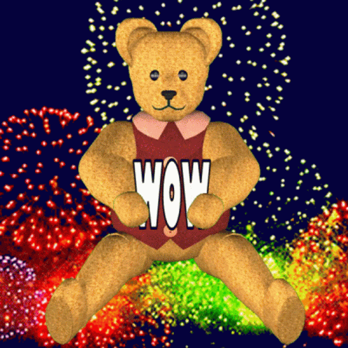 a blue bear is sitting on a background full of fireworks
