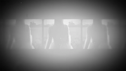 silhouettes of people standing in front of window in darkroom