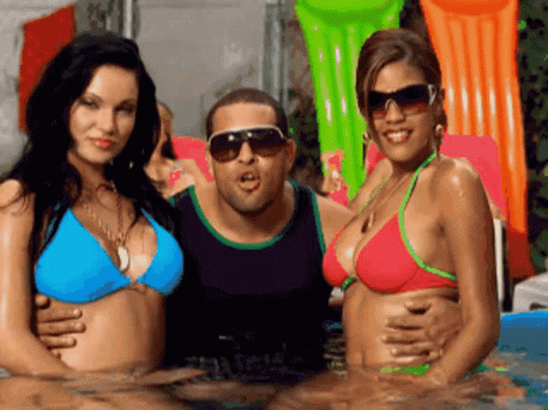 the four women are in the pool with the man wearing sunglasses