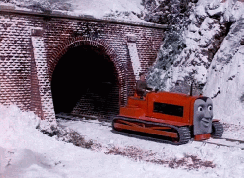 thomas the train coming out of a tunnel in a mountain