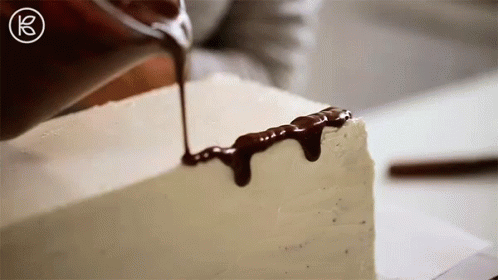 chocolate dripping onto an artistic design, on a white block