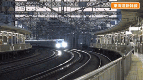 a train moving down some tracks in an empty station