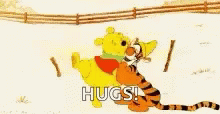 the word hugs with a blue tiger standing in the snow