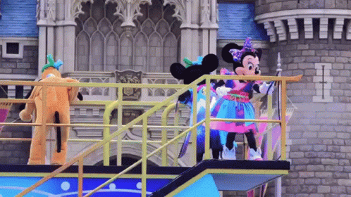 mickey and minnie on stage with a castle in the background