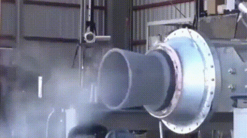 a blow - blown machine is inside a factory with pipes