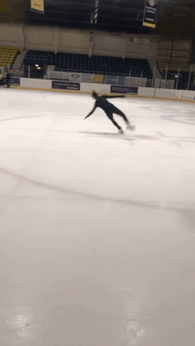 a man is skating on the ice rink