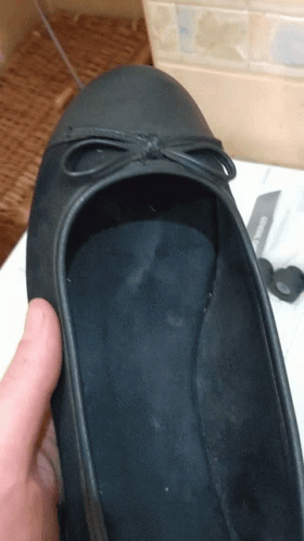 a pair of shoes with a knife in the background