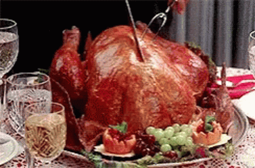 a large stuffed turkey on a table with blue decorations
