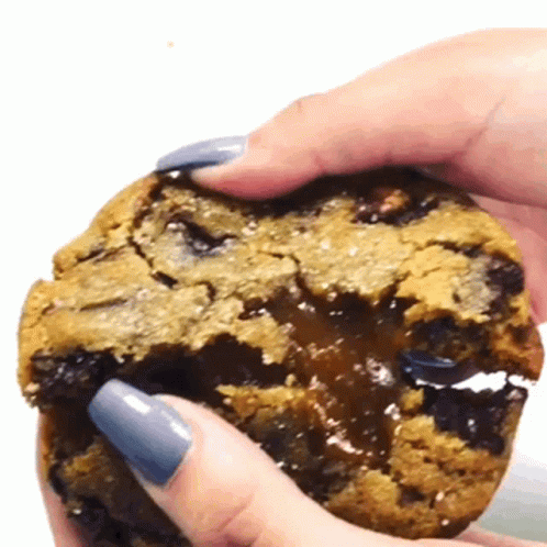 someone is putting soing inside a cookie with blue icing
