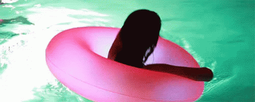 a person is swimming in a large purple body of water