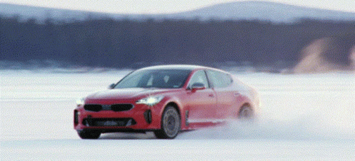 a car driving on a frozen lake during the day