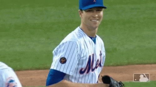a baseball player on the field holding a ball