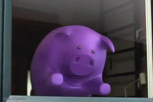 a plastic pig sitting in the window of a store