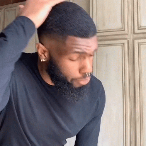 a man with a beard is getting ready to shave his hair