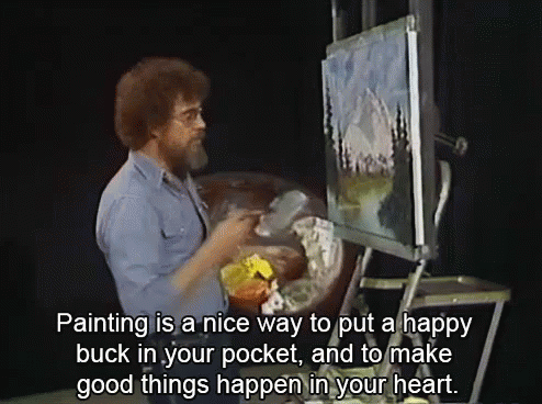 a man in tan is using an easel and an ocean scene