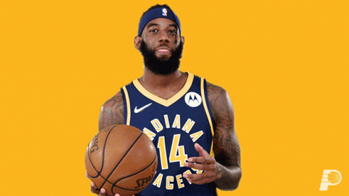 a basketball player with a beard holding a basketball