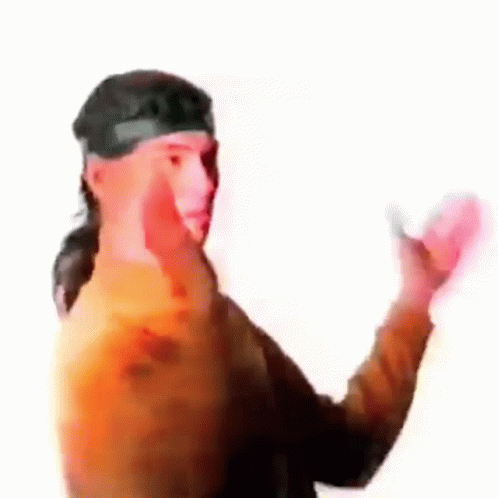 a guy in a shirt and headband holding his hands out