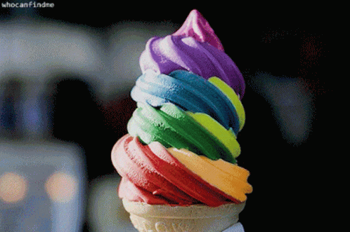 the colorful ice cream is in a cone