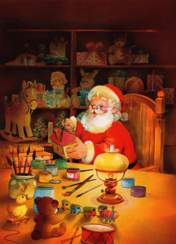 santa claus sits at a table in the middle of blue room