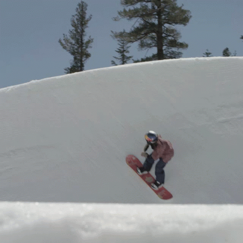 person riding snowboard down the side of hill