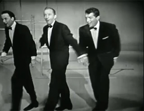 three men in suits walk next to each other