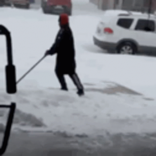 a man pulling a woman down the street on skis