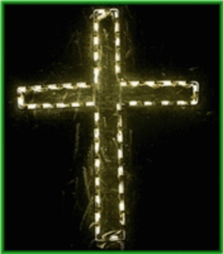 green framed po of an illuminated cross in dark